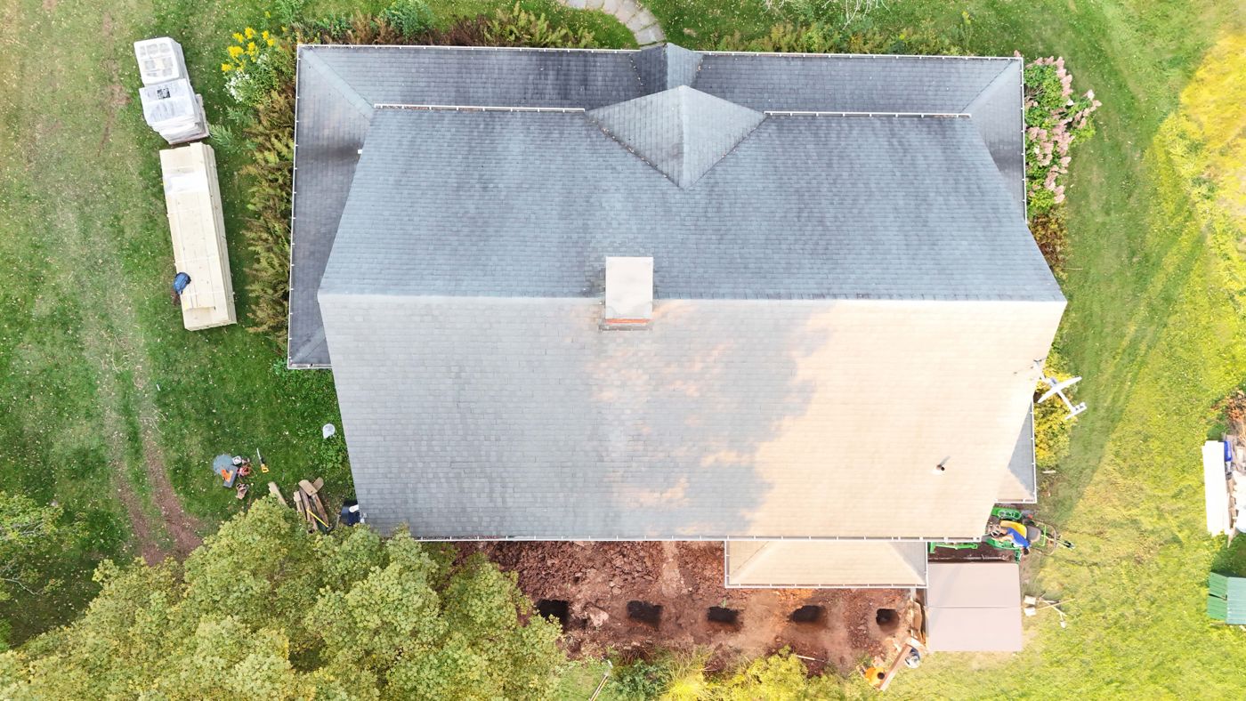 Drone view of the footing holes laid out along the back of the house before framing