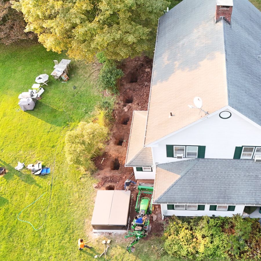 Drone view of footing holes dug along the back of the house